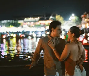 Couple talking beside city lights at night